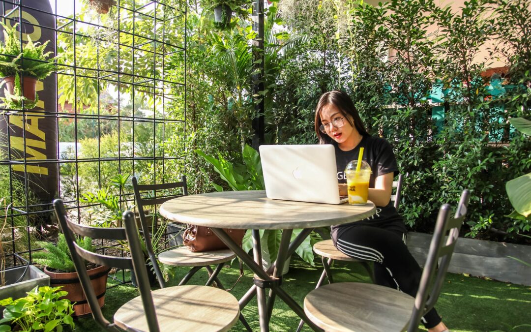 woman sitting on chair while using laptop