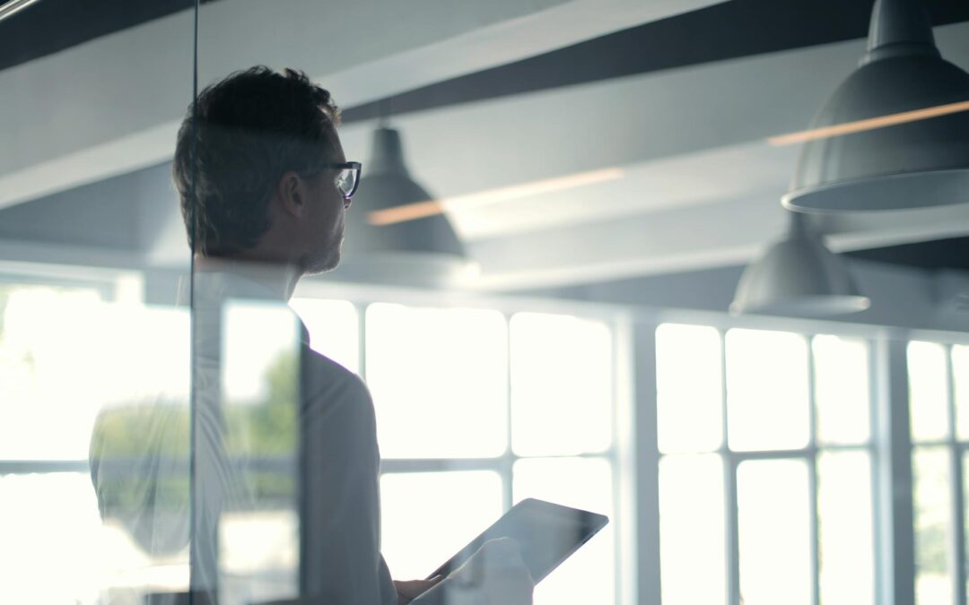 formal man with tablet giving presentation in office